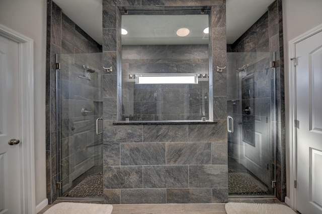 bathroom with a shower with shower door