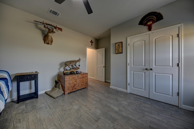 bedroom featuring hardwood / wood-style floors, a closet, and ceiling fan