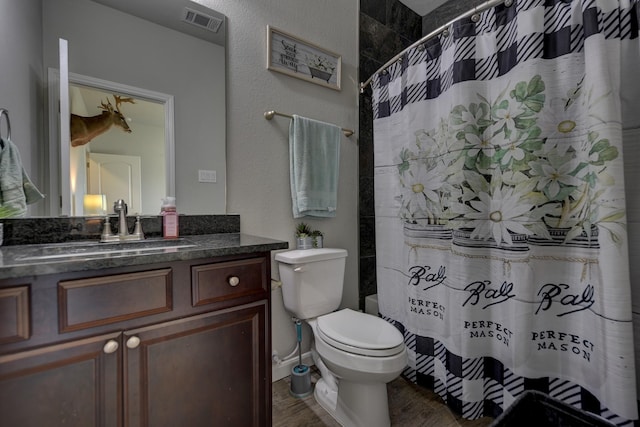 bathroom featuring hardwood / wood-style flooring, toilet, vanity, and a shower with shower curtain