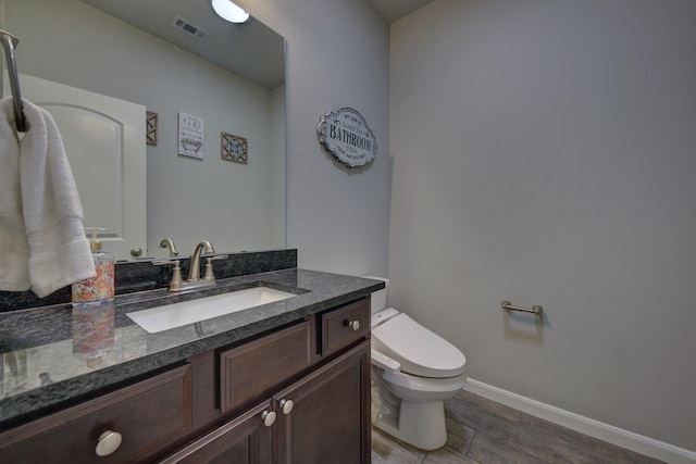 bathroom with toilet and vanity