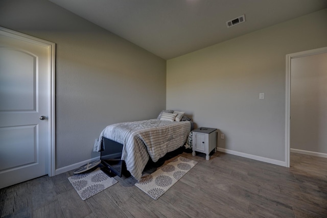 bedroom with hardwood / wood-style floors