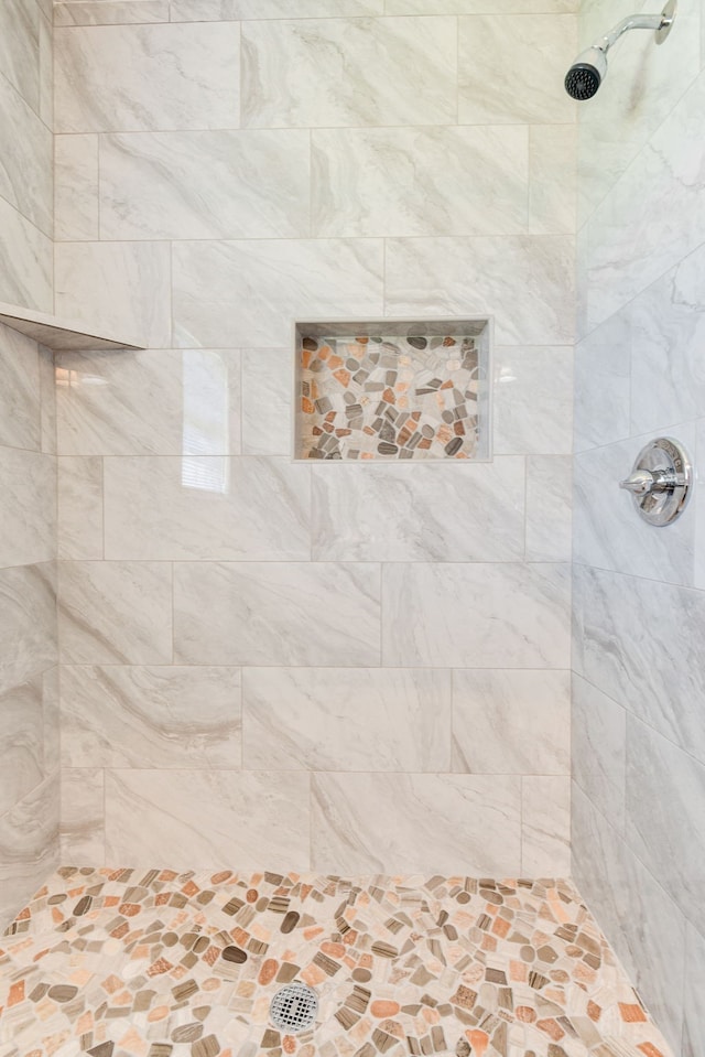 bathroom with tiled shower