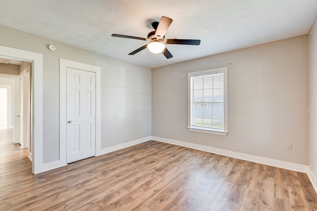 empty room featuring ceiling fan and light hardwood / wood-style flooring