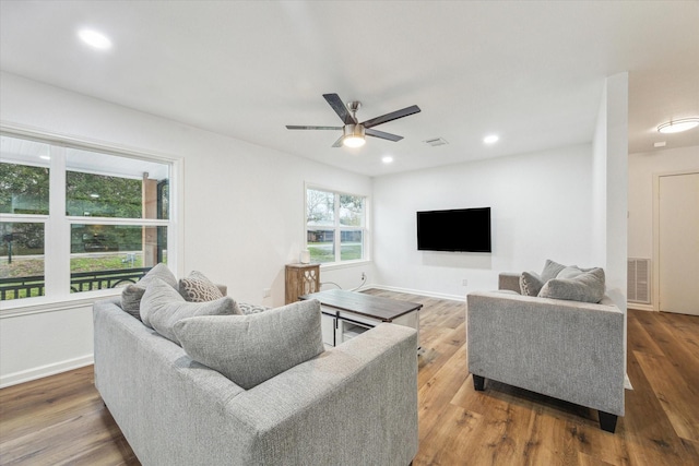 living room with ceiling fan, a wealth of natural light, and hardwood / wood-style floors