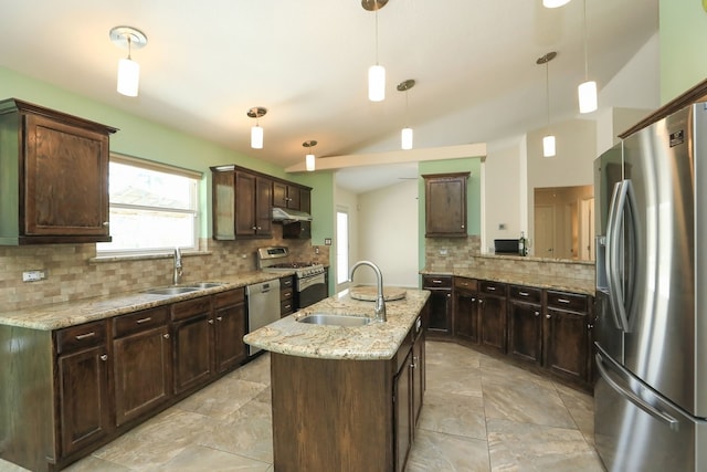 kitchen with vaulted ceiling, pendant lighting, sink, an island with sink, and stainless steel appliances