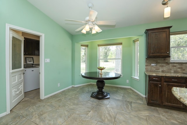 kitchen featuring ceiling fan, dark brown cabinets, light stone counters, and tasteful backsplash