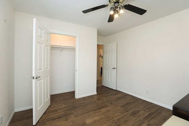 unfurnished bedroom with ceiling fan, a closet, and dark hardwood / wood-style flooring