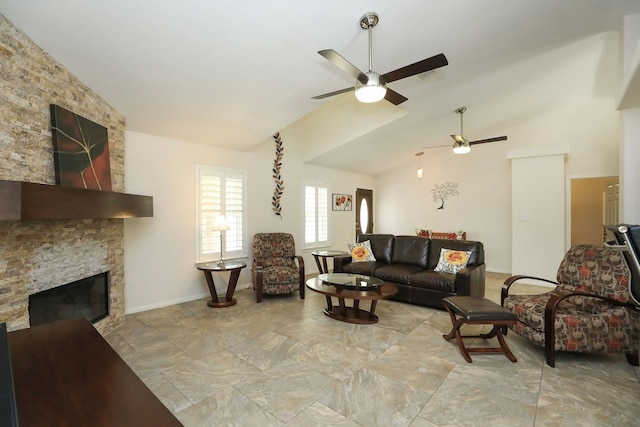 living room featuring ceiling fan, a stone fireplace, and vaulted ceiling