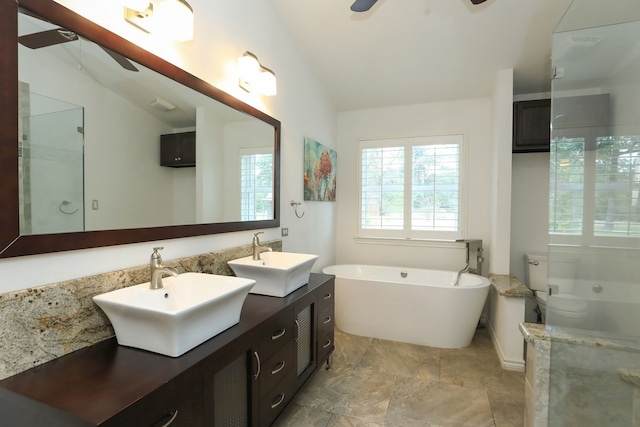 full bathroom featuring toilet, vanity, vaulted ceiling, and separate shower and tub