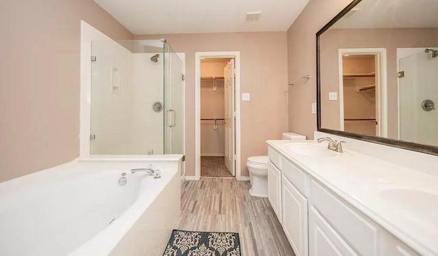 full bathroom with separate shower and tub, vanity, toilet, and hardwood / wood-style flooring