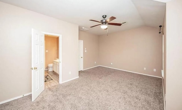 spare room featuring ceiling fan, lofted ceiling, and light colored carpet