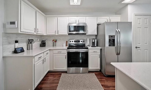 kitchen with white cabinetry, stainless steel appliances, and tasteful backsplash