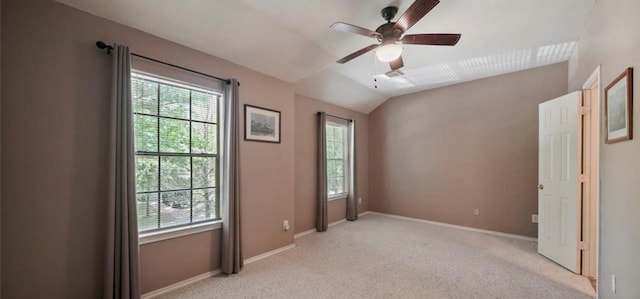 unfurnished bedroom featuring ceiling fan, light colored carpet, and vaulted ceiling