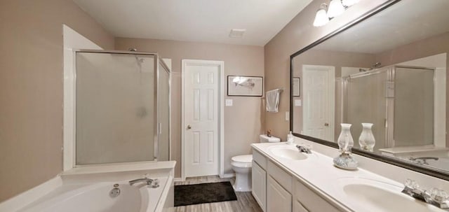 full bathroom with toilet, vanity, hardwood / wood-style flooring, and shower with separate bathtub