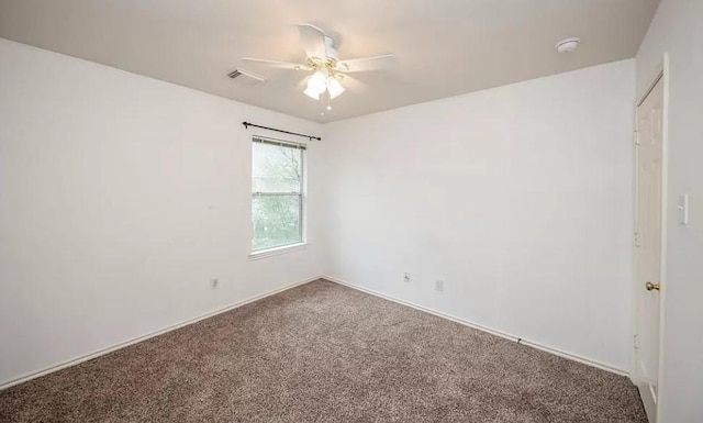 spare room featuring ceiling fan and carpet