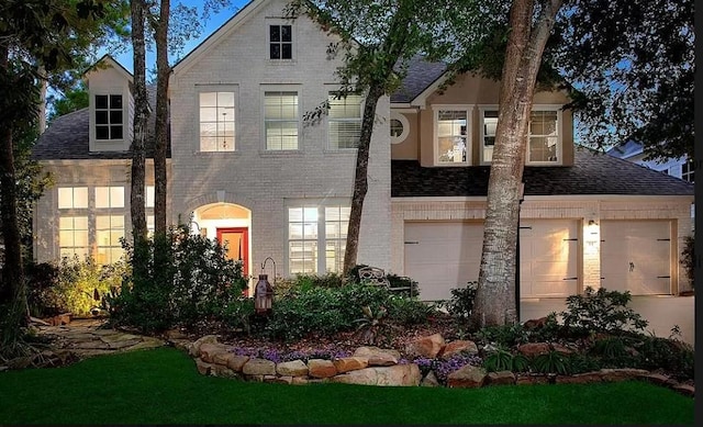 view of front of house featuring a front yard and a garage