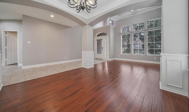 interior space featuring crown molding, a chandelier, and light hardwood / wood-style flooring