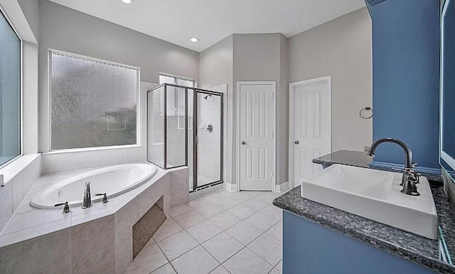 bathroom featuring independent shower and bath, tile patterned flooring, and sink