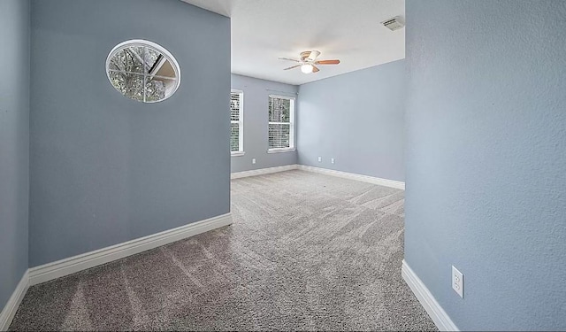 carpeted spare room with ceiling fan