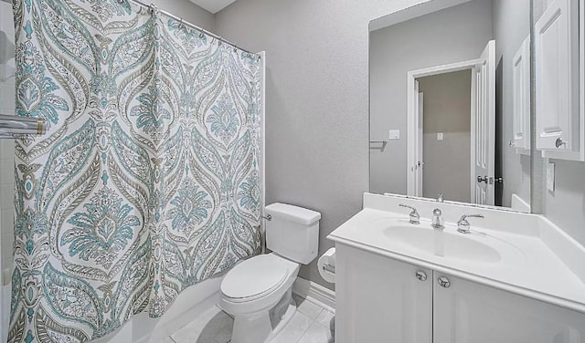 bathroom with toilet, vanity, and tile patterned flooring