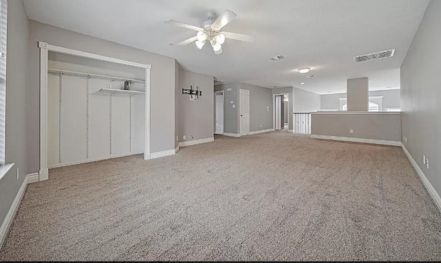 unfurnished living room with ceiling fan and carpet floors