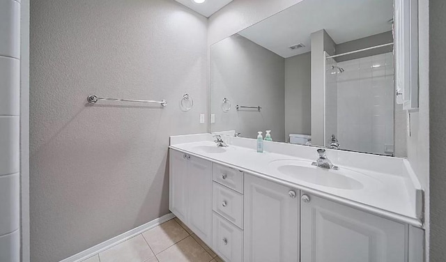 bathroom with toilet, tile patterned flooring, a shower, and vanity