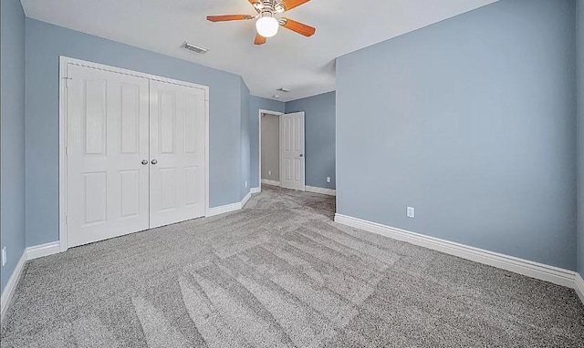 unfurnished bedroom featuring ceiling fan, a closet, and carpet floors