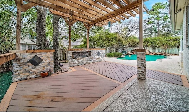 wooden deck featuring a fenced in pool and a pergola