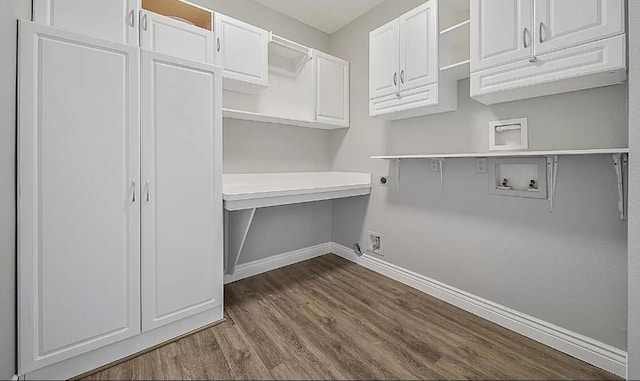 washroom featuring cabinets, hardwood / wood-style flooring, hookup for a washing machine, and hookup for an electric dryer