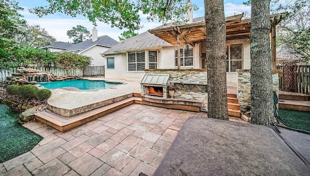 back of property with a fenced in pool and a patio