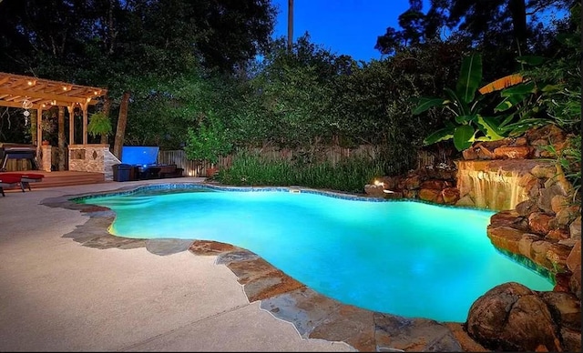 view of pool with a pergola, a patio area, and a wooden deck