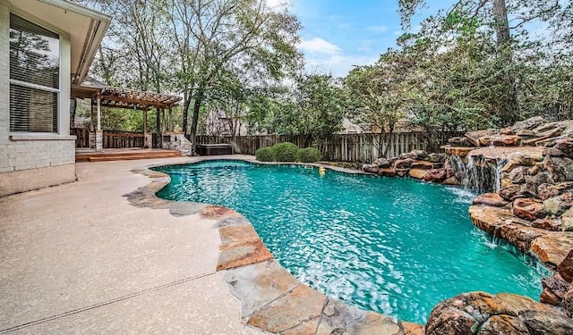 view of swimming pool featuring pool water feature and a patio area