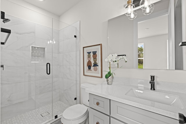 bathroom featuring toilet, vanity, and an enclosed shower