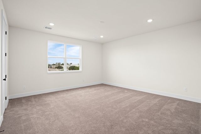 unfurnished room featuring carpet