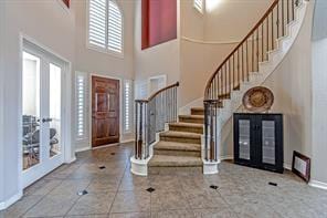 entrance foyer with a towering ceiling and french doors