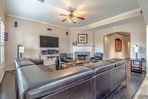 living room with ceiling fan and crown molding