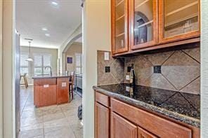 kitchen featuring decorative backsplash, pendant lighting, and light tile patterned floors