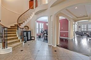 foyer featuring a tray ceiling and tile patterned floors