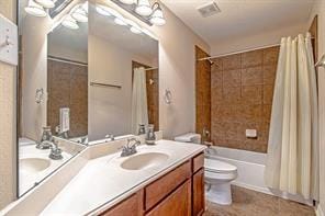 full bathroom featuring toilet, vanity, and shower / tub combo with curtain