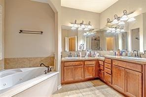 bathroom featuring tile patterned floors, a washtub, and vanity