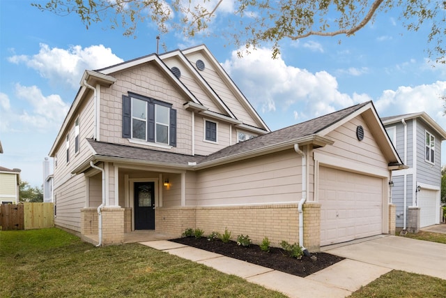 craftsman-style home featuring a front lawn and a garage