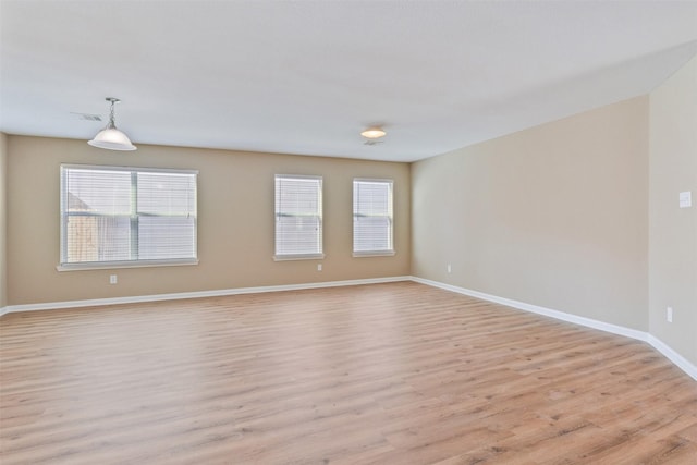 spare room featuring light hardwood / wood-style flooring