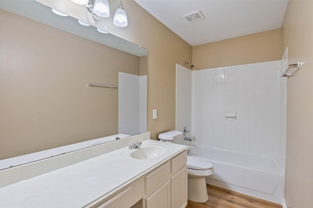 full bathroom with toilet, vanity, wood-type flooring, and bathing tub / shower combination