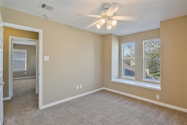 unfurnished room with light carpet and ceiling fan