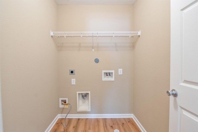 washroom featuring washer hookup, electric dryer hookup, and hardwood / wood-style flooring