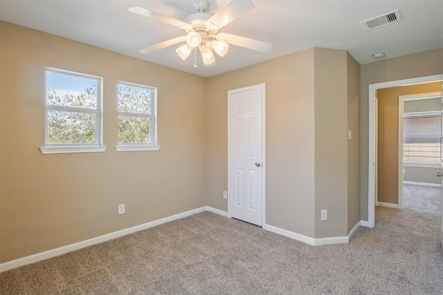 unfurnished bedroom with ceiling fan and light colored carpet