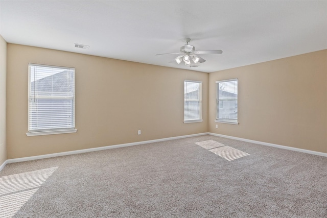 unfurnished room with ceiling fan and carpet flooring