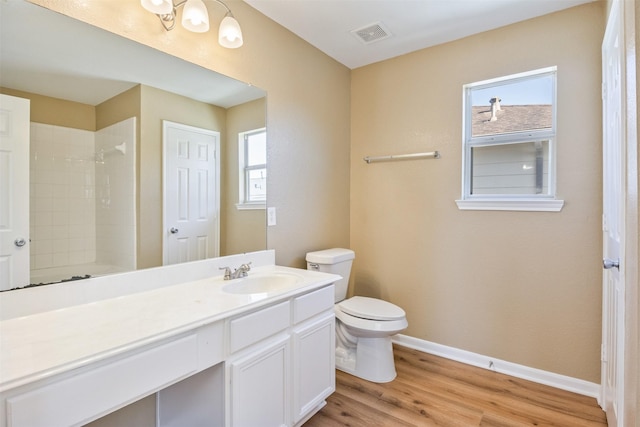 bathroom with toilet, a shower, hardwood / wood-style floors, and vanity