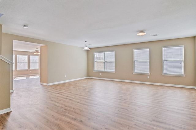 empty room featuring light hardwood / wood-style floors and plenty of natural light