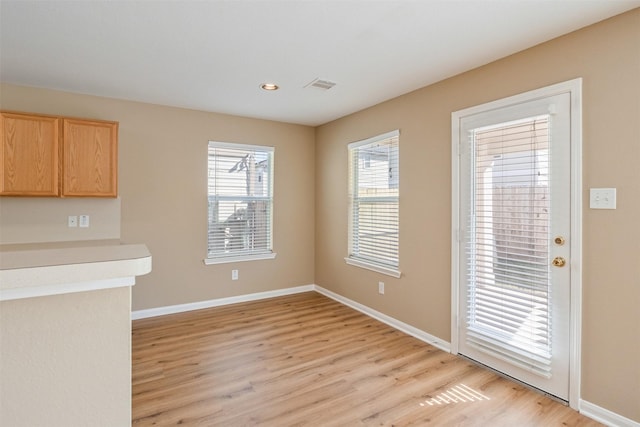 unfurnished dining area featuring light hardwood / wood-style floors